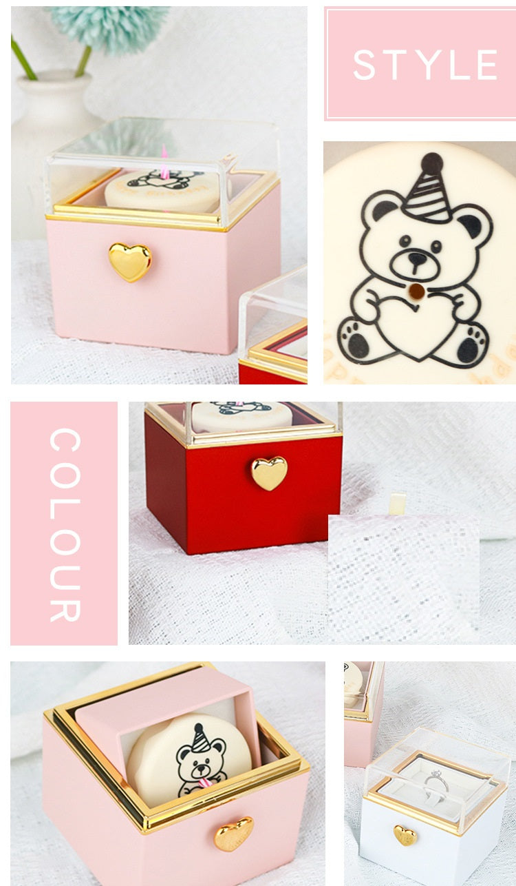 Cute bear-themed gift boxes in pink, red, and white with gold heart accents and clear lids.