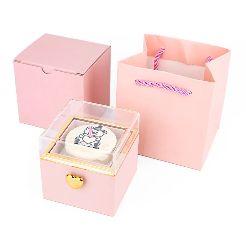 Pink gift box with heart lock, clear lid, and teddy bear candle, paired with matching paper bag