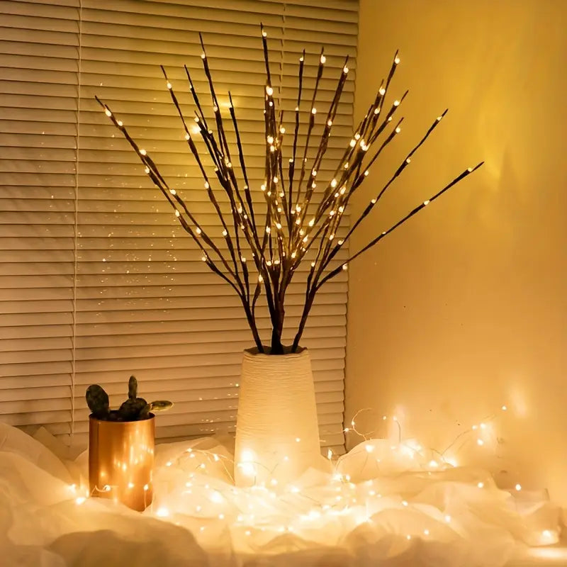 Decorative LED branch lamp in a vase with soft lighting in a room setting.