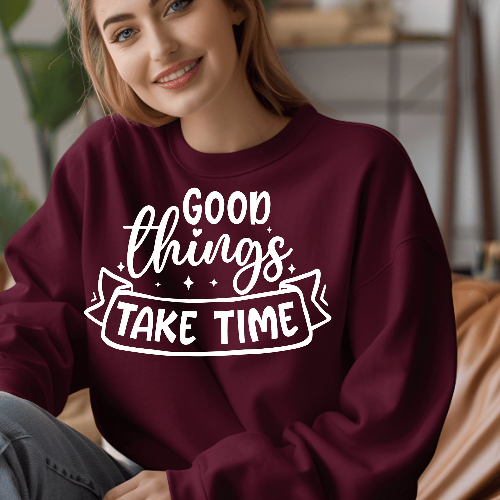 Person wearing a maroon sweatshirt with 'Good things take time' text.