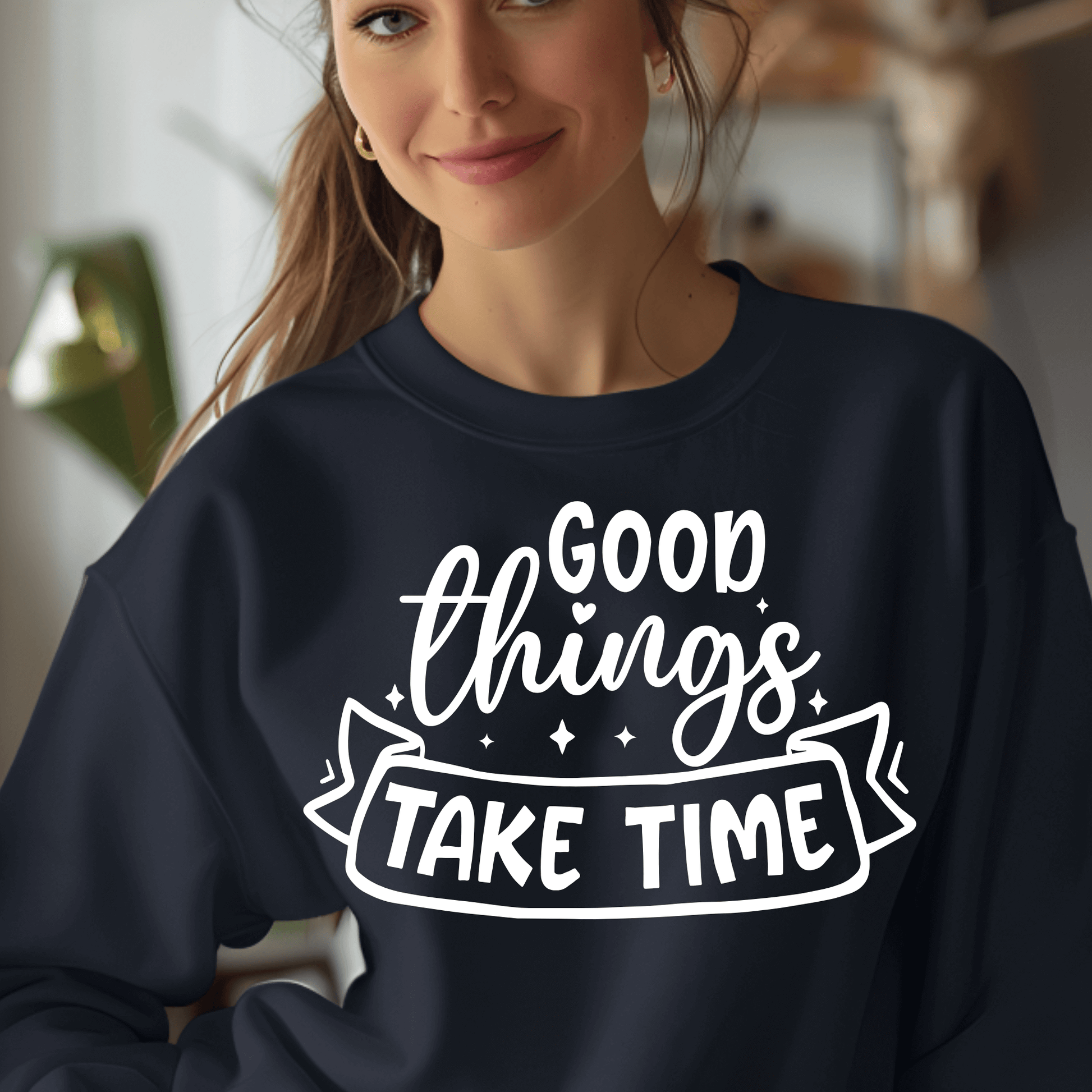Person wearing a navy sweatshirt with 'Good things take time' text