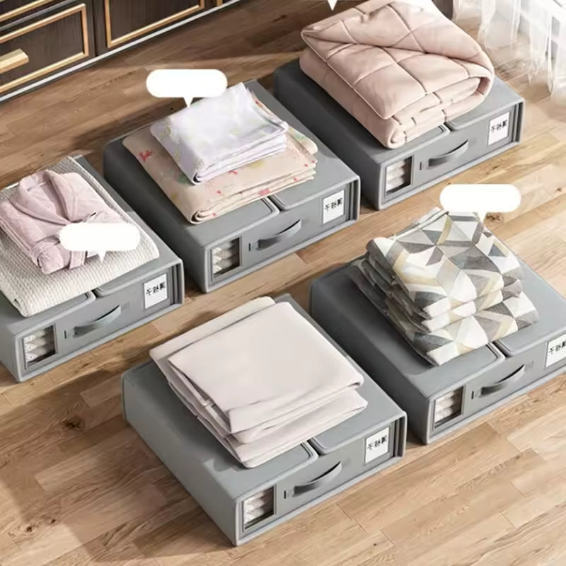 Gray storage boxes with folded clothes on a wooden floor