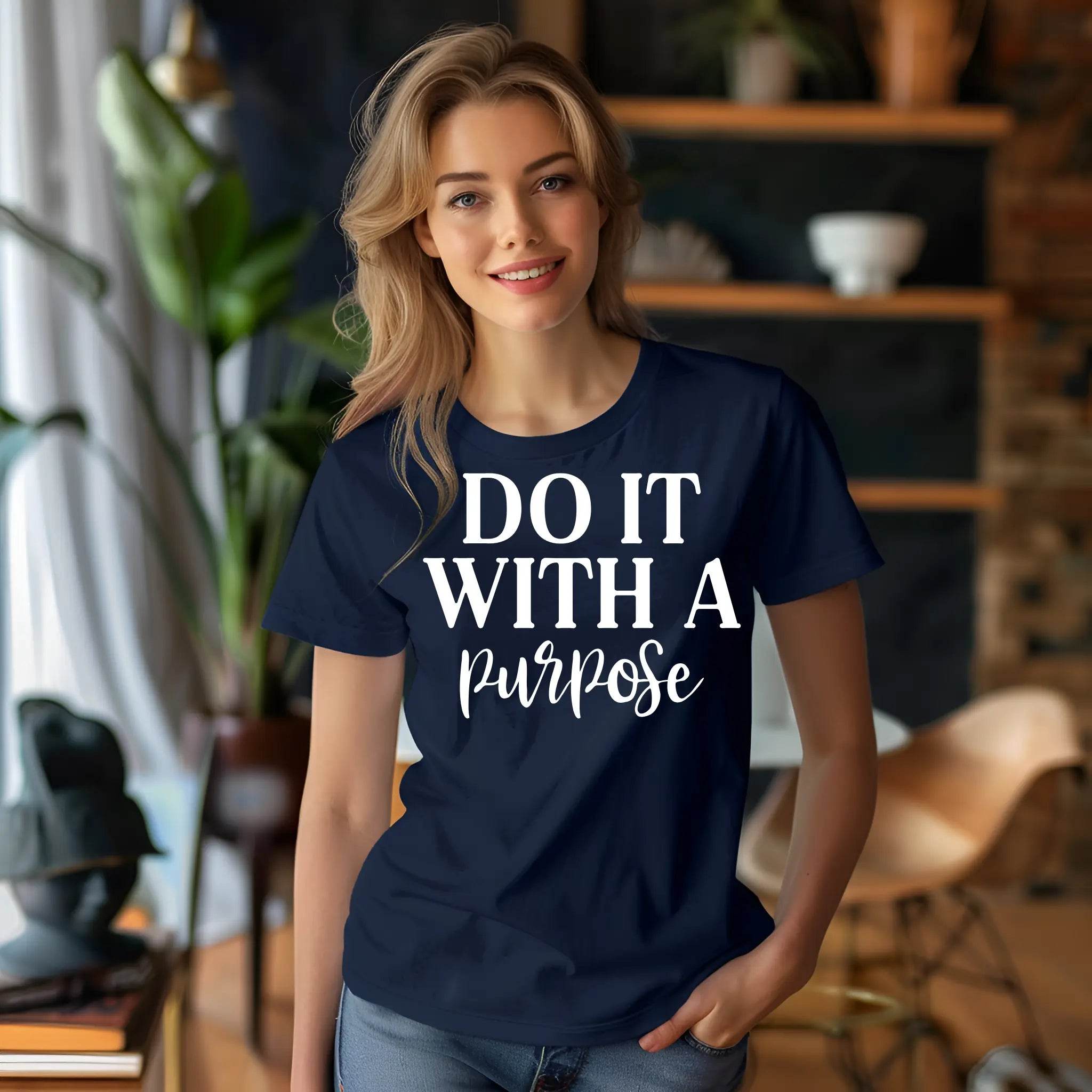 Woman wearing a navy blue t-shirt with 'DO IT WITH A Purpose' text in a casual indoor setting.
