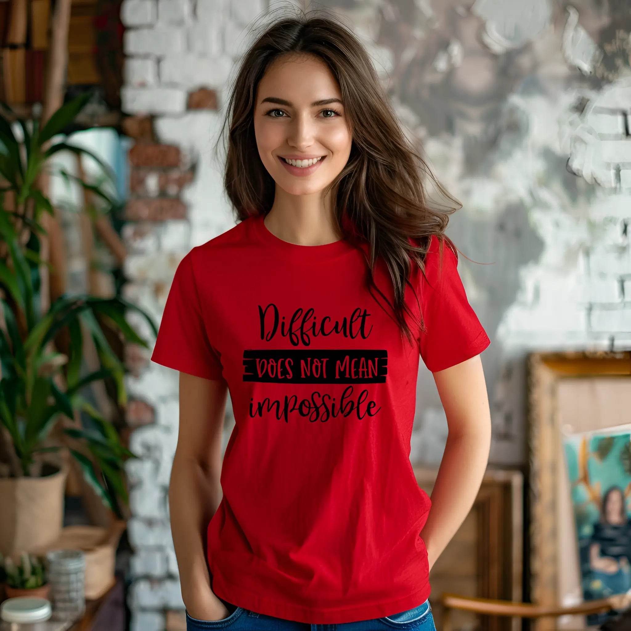 Woman wearing a red t-shirt with motivational text in a casual indoor setting