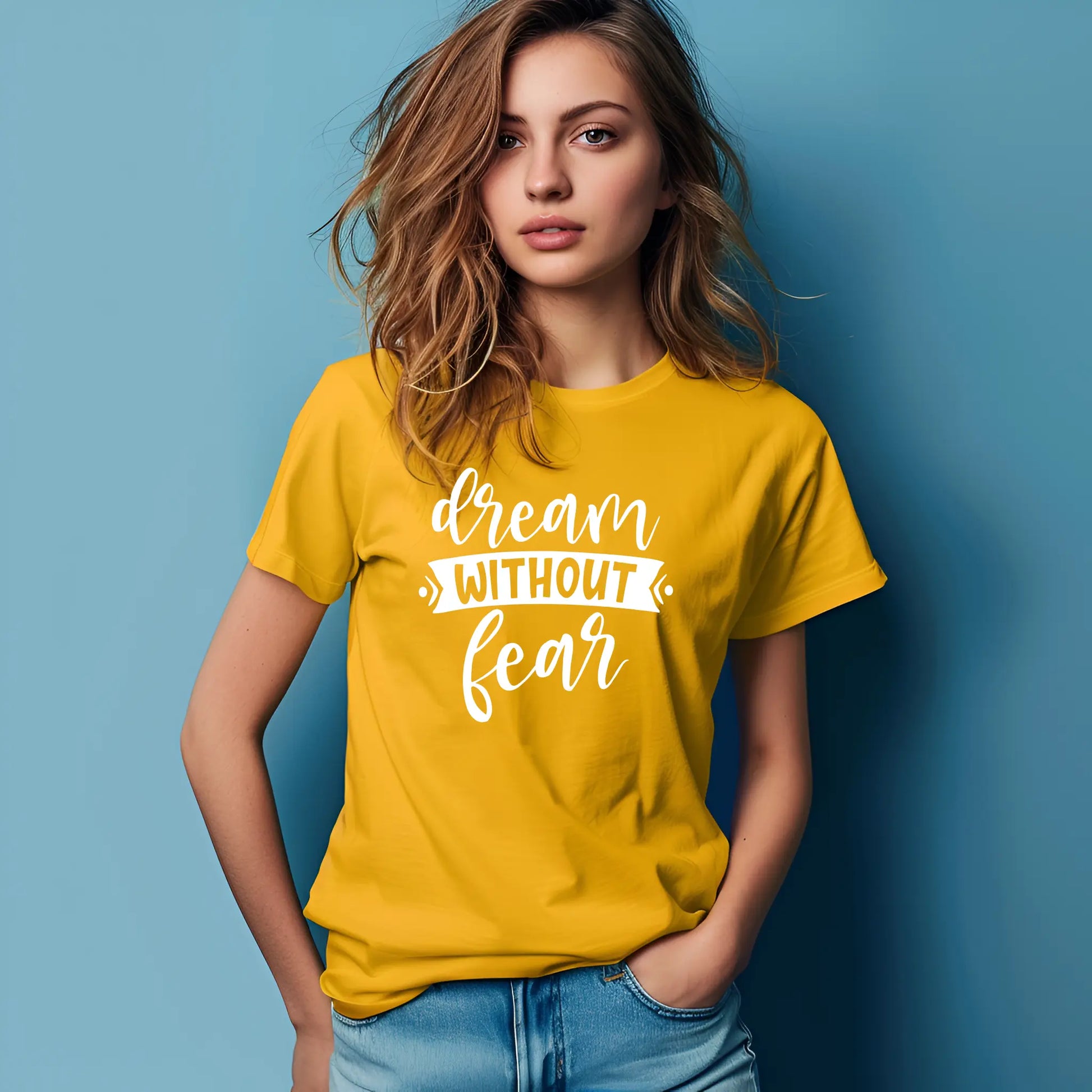 Woman wearing a yellow t-shirt with 'dream without fear' text against a blue background