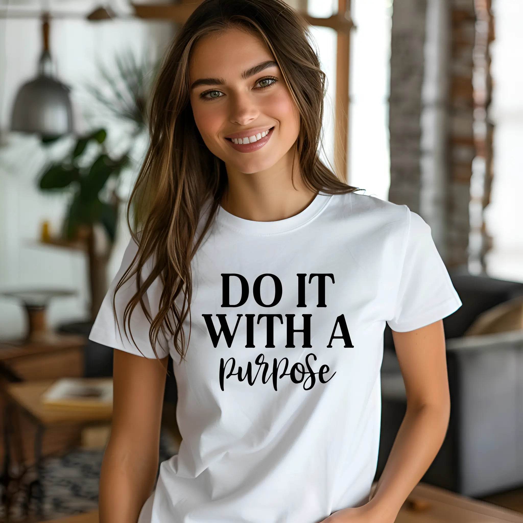 Woman wearing a white t-shirt with 'DO IT WITH A PURPOSE' text in a casual indoor setting.