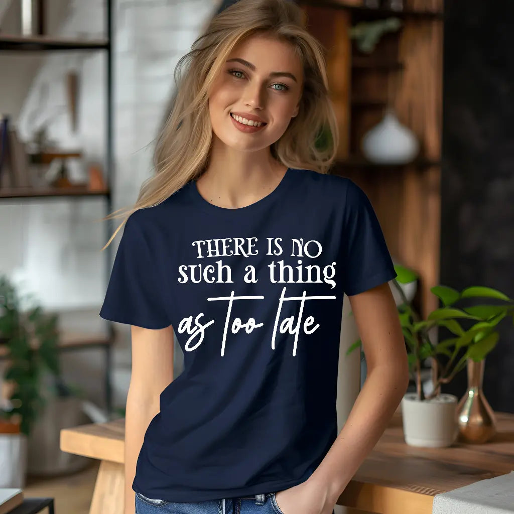 Woman wearing a navy blue t-shirt with motivational quote in a home setting