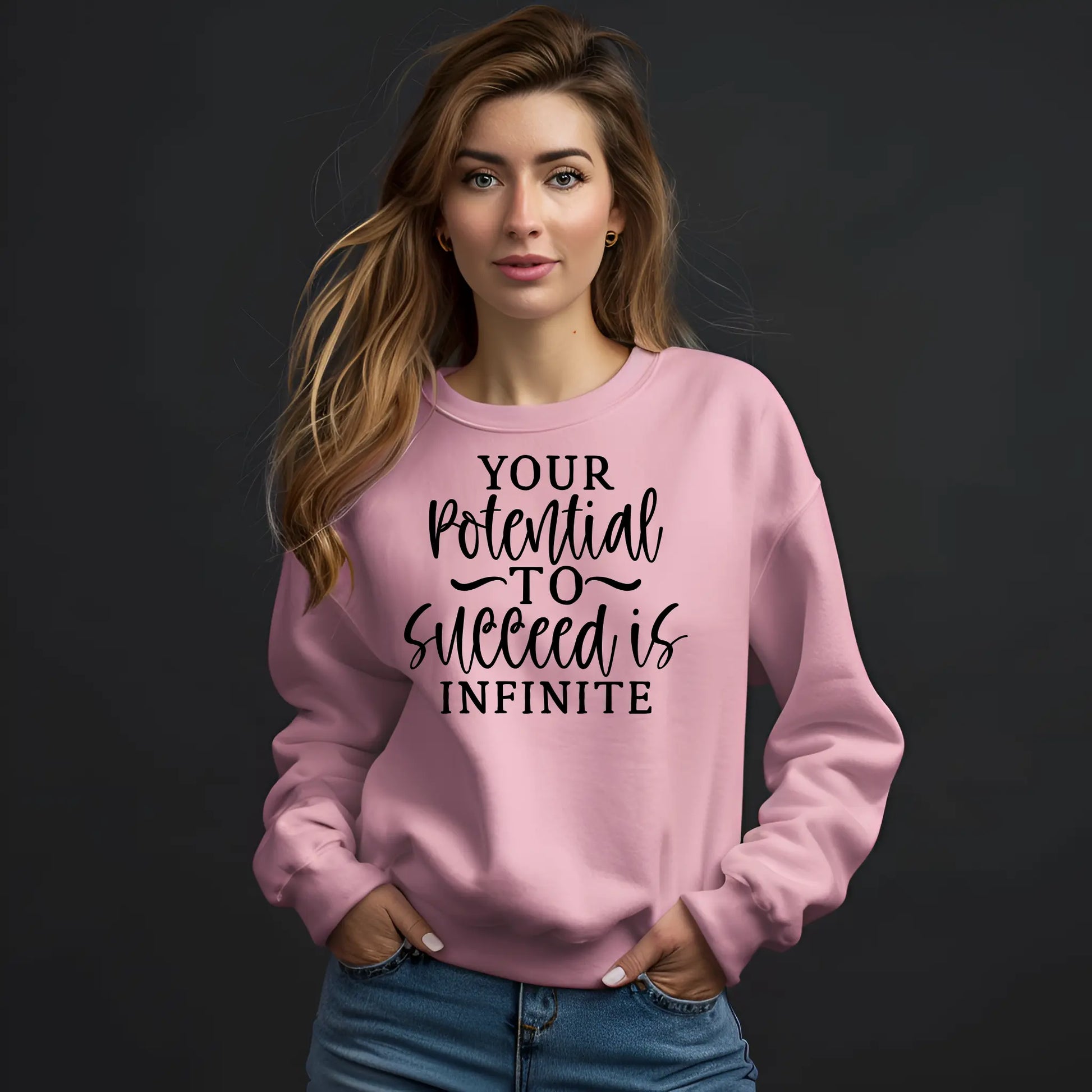 Woman wearing a pink sweatshirt with motivational text on a black background