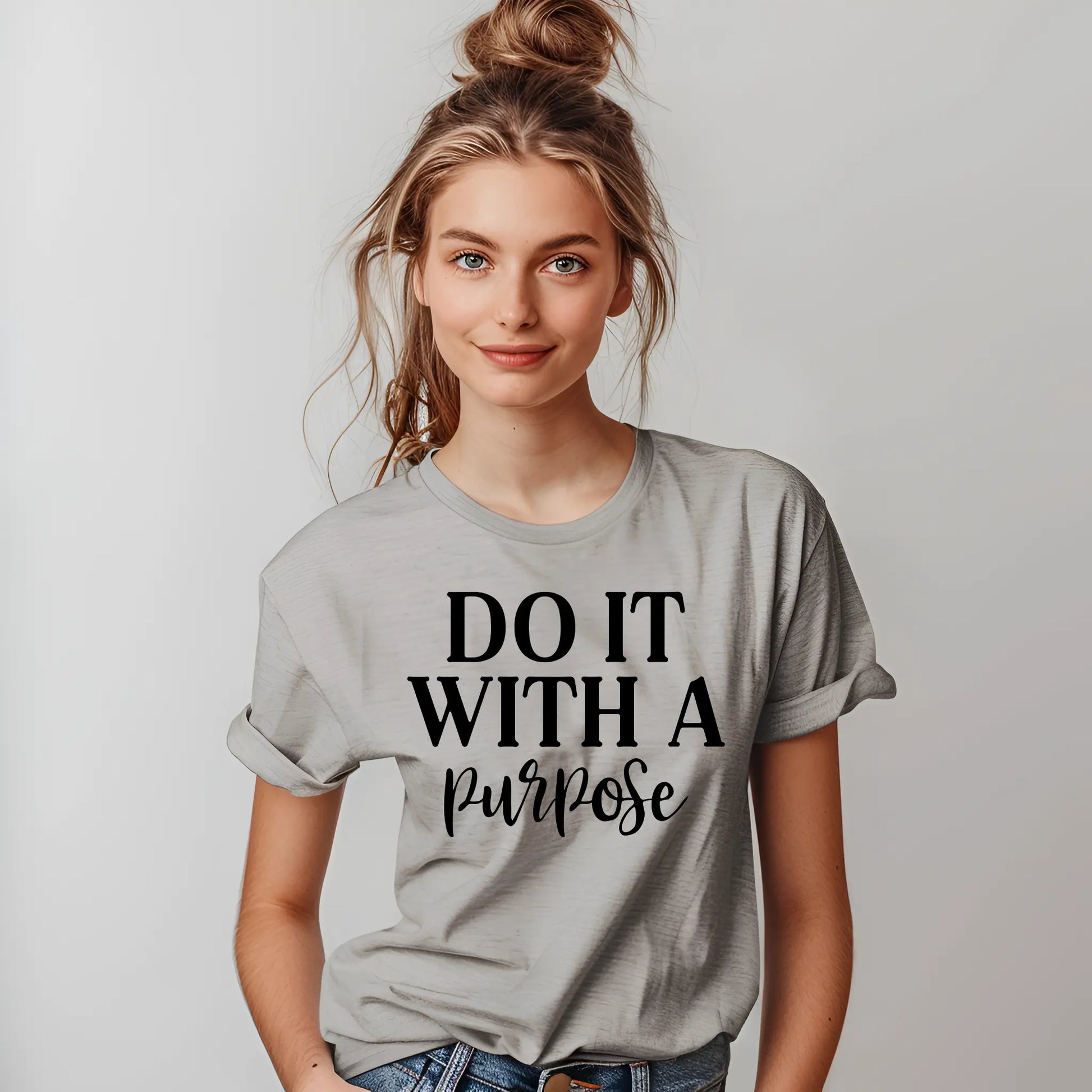 Person wearing a gray t-shirt with 'Do It With A Purpose' text on a plain background