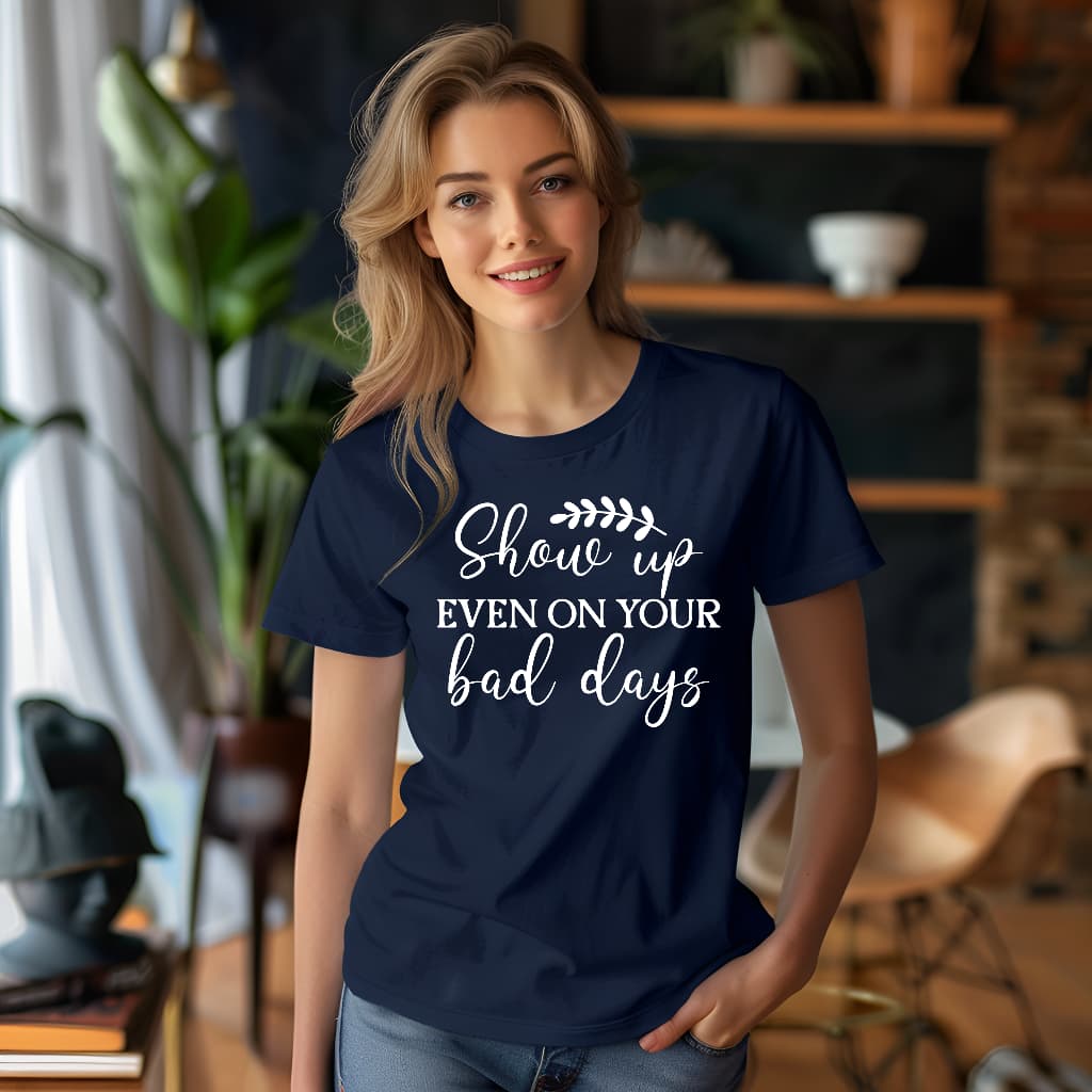 Woman wearing a navy blue t-shirt with motivational quote in a home setting