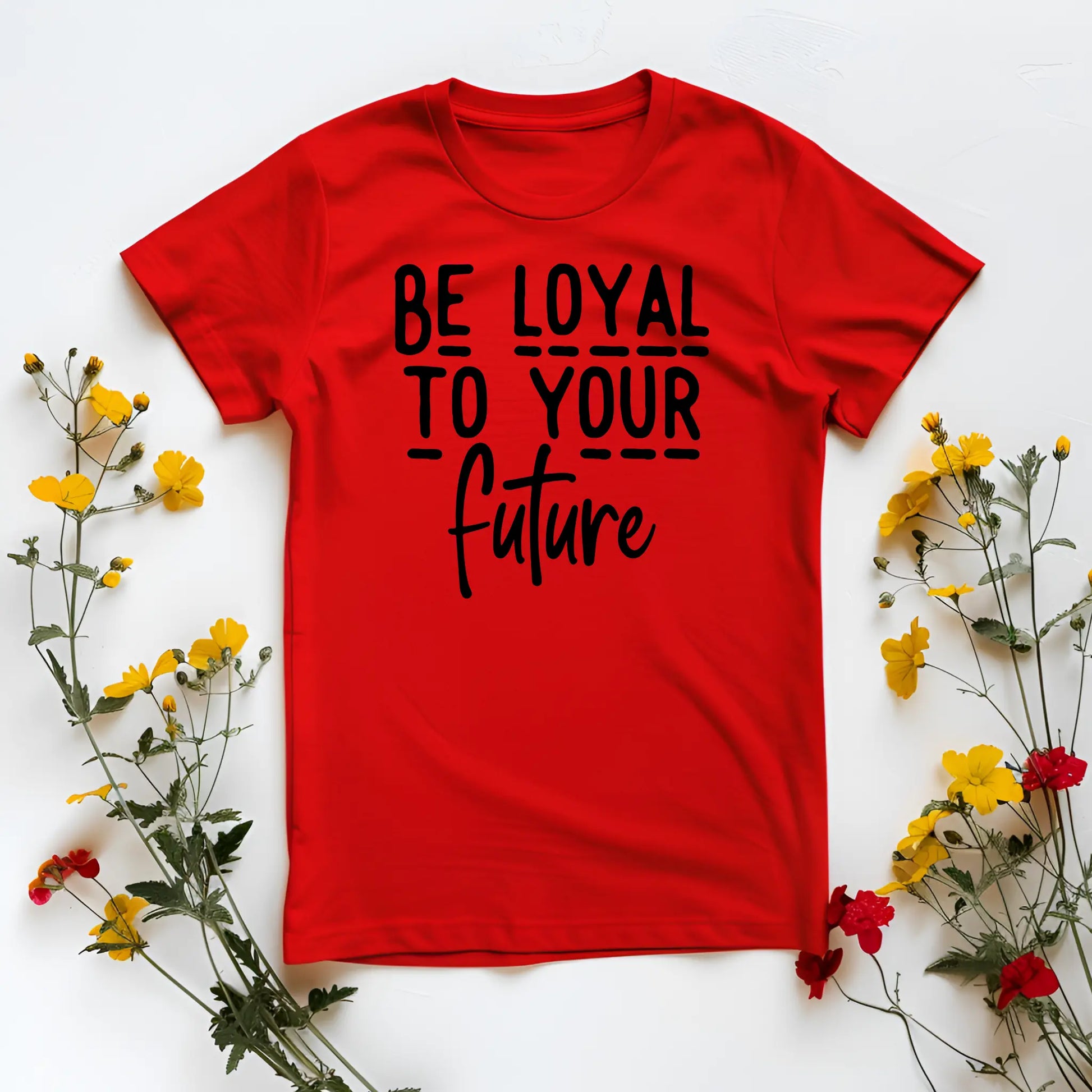 Red t-shirt with 'Be loyal to your future' text on a white background with flowers.