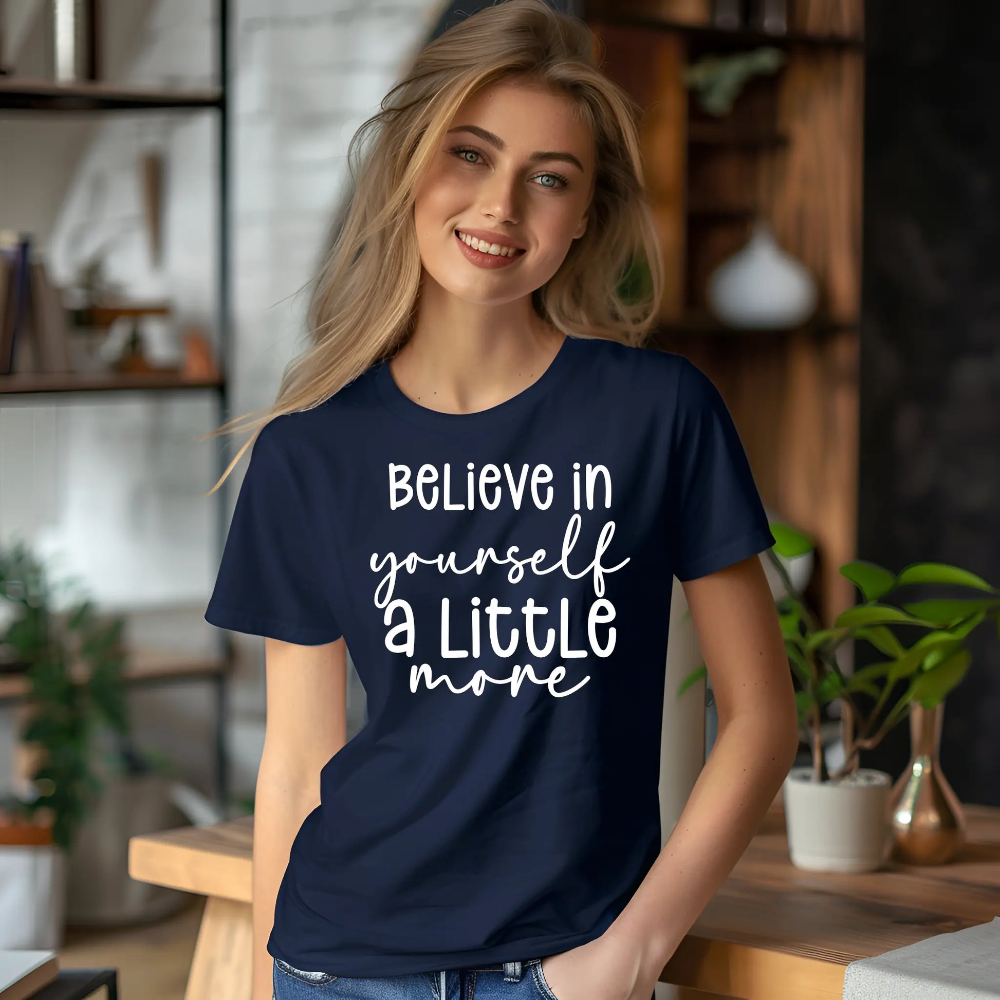 Woman wearing a navy blue t-shirt with motivational quote in a home setting