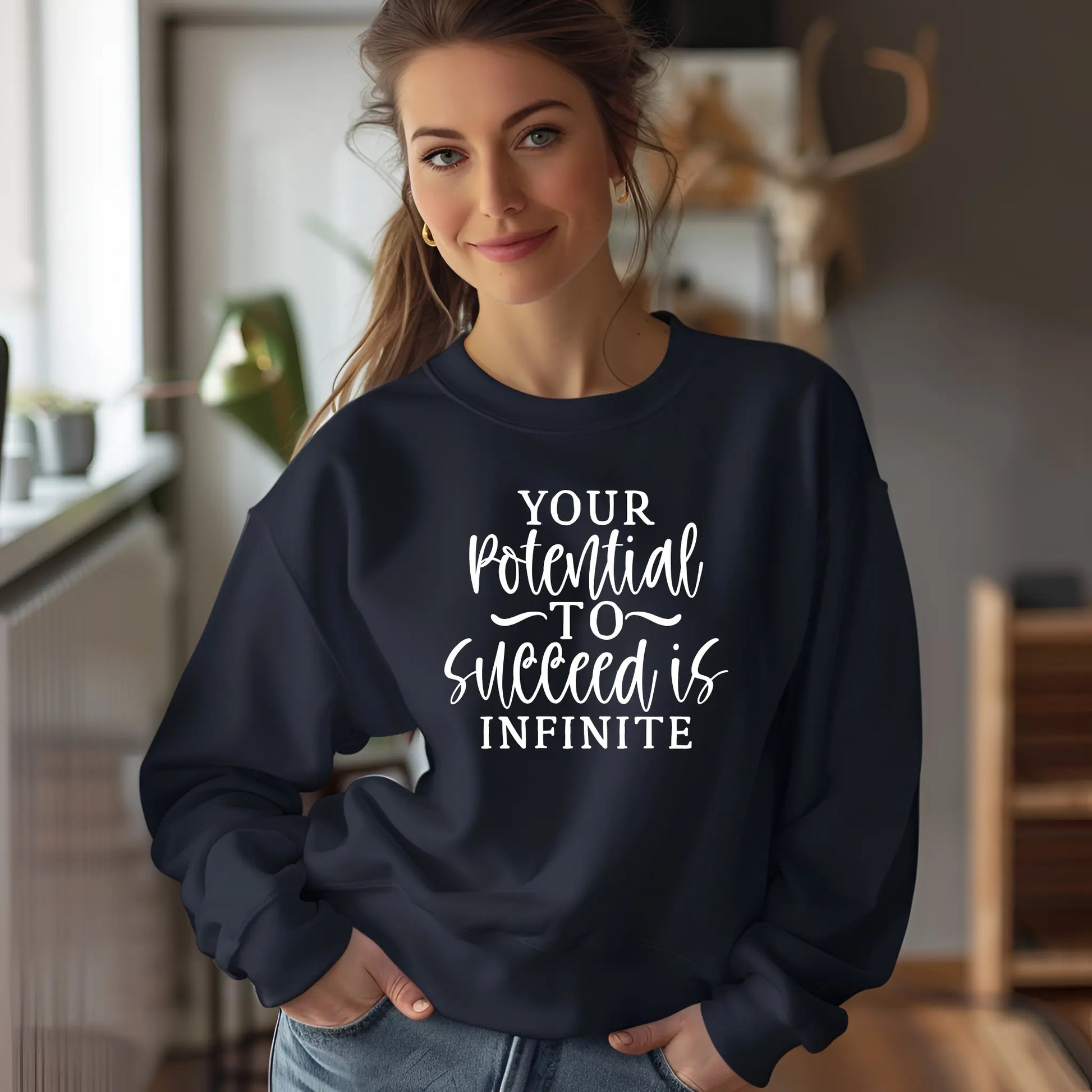 Person wearing a navy sweatshirt with motivational quote in a home setting