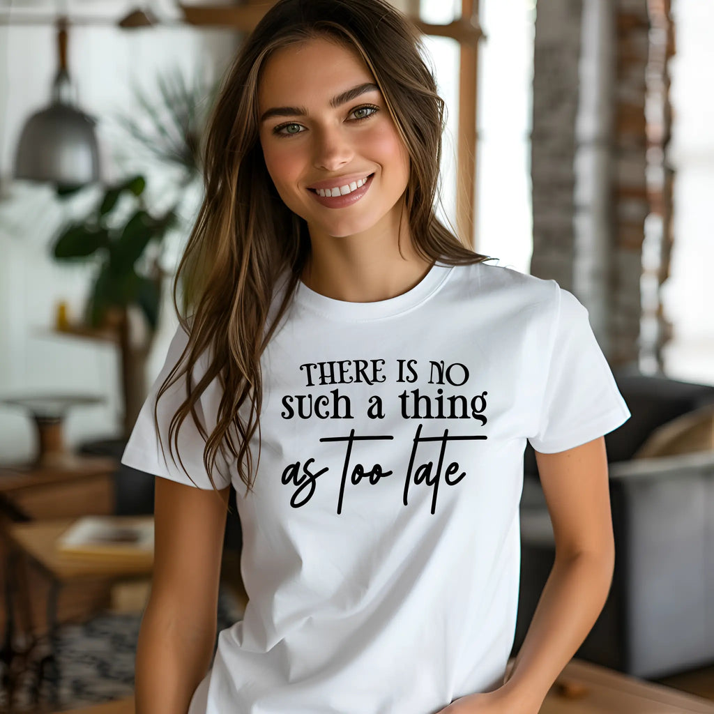 Woman wearing a white t-shirt with motivational text in a casual indoor setting