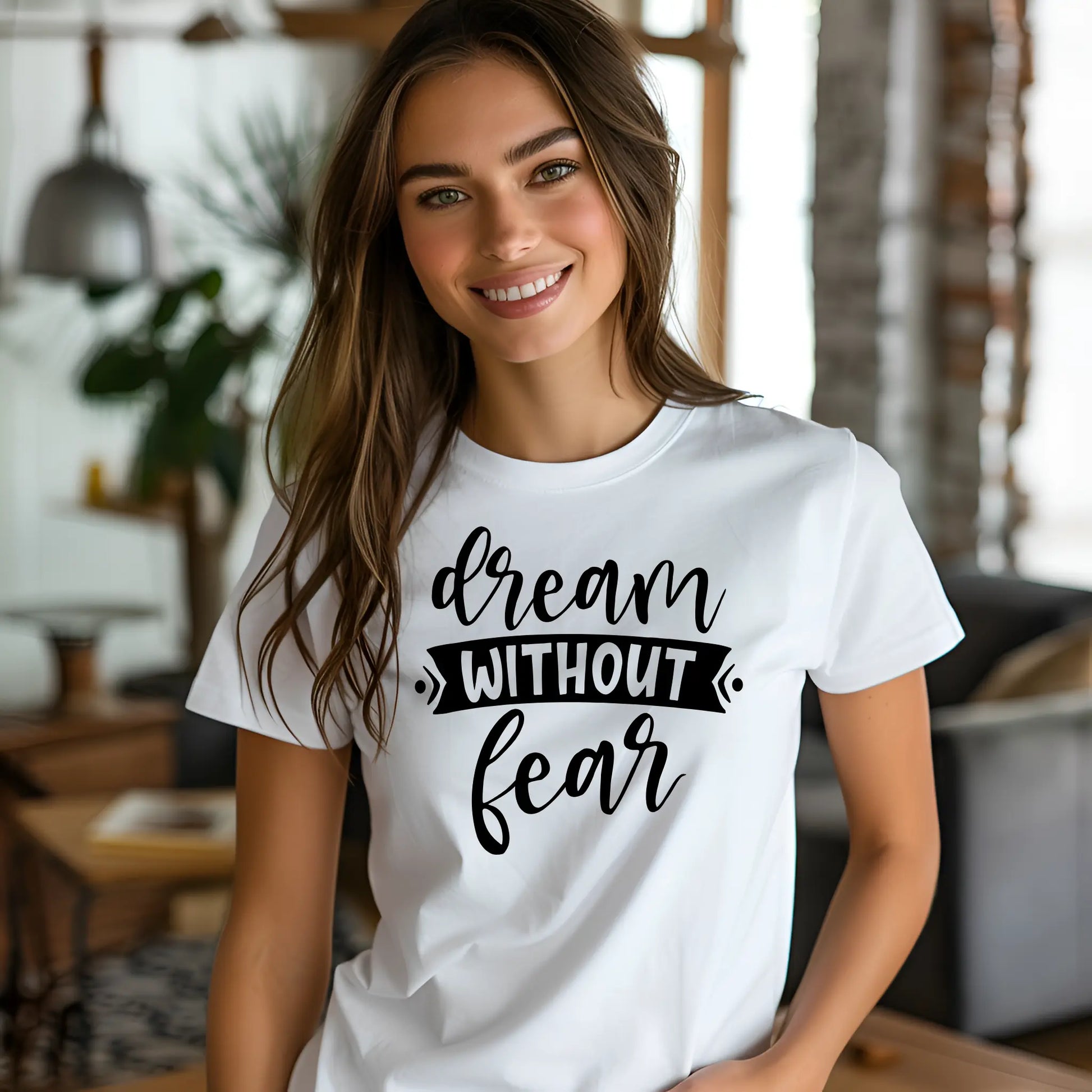 Woman wearing a white t-shirt with 'dream without fear' text in a casual indoor setting