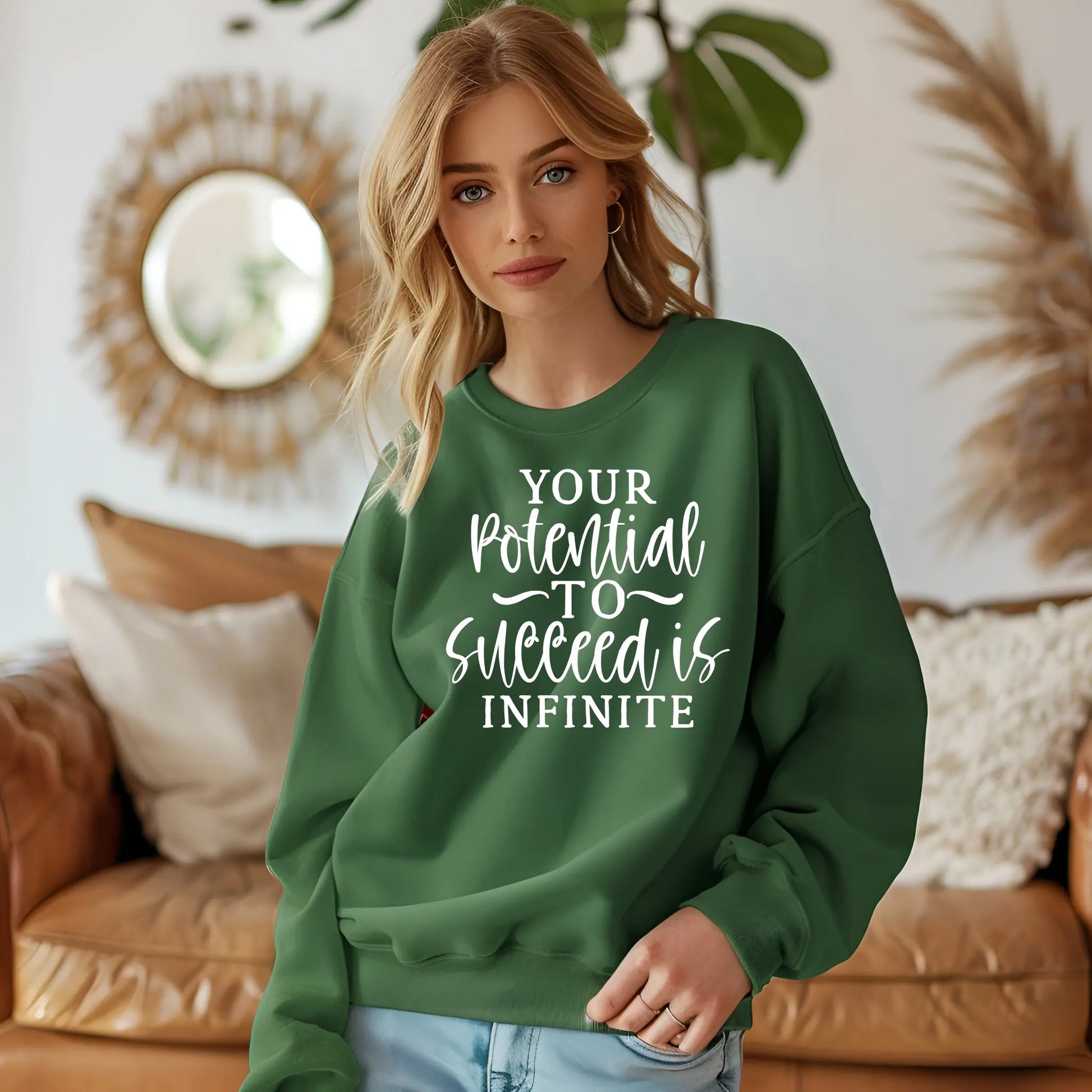 Woman wearing a green sweatshirt with motivational text in a home setting