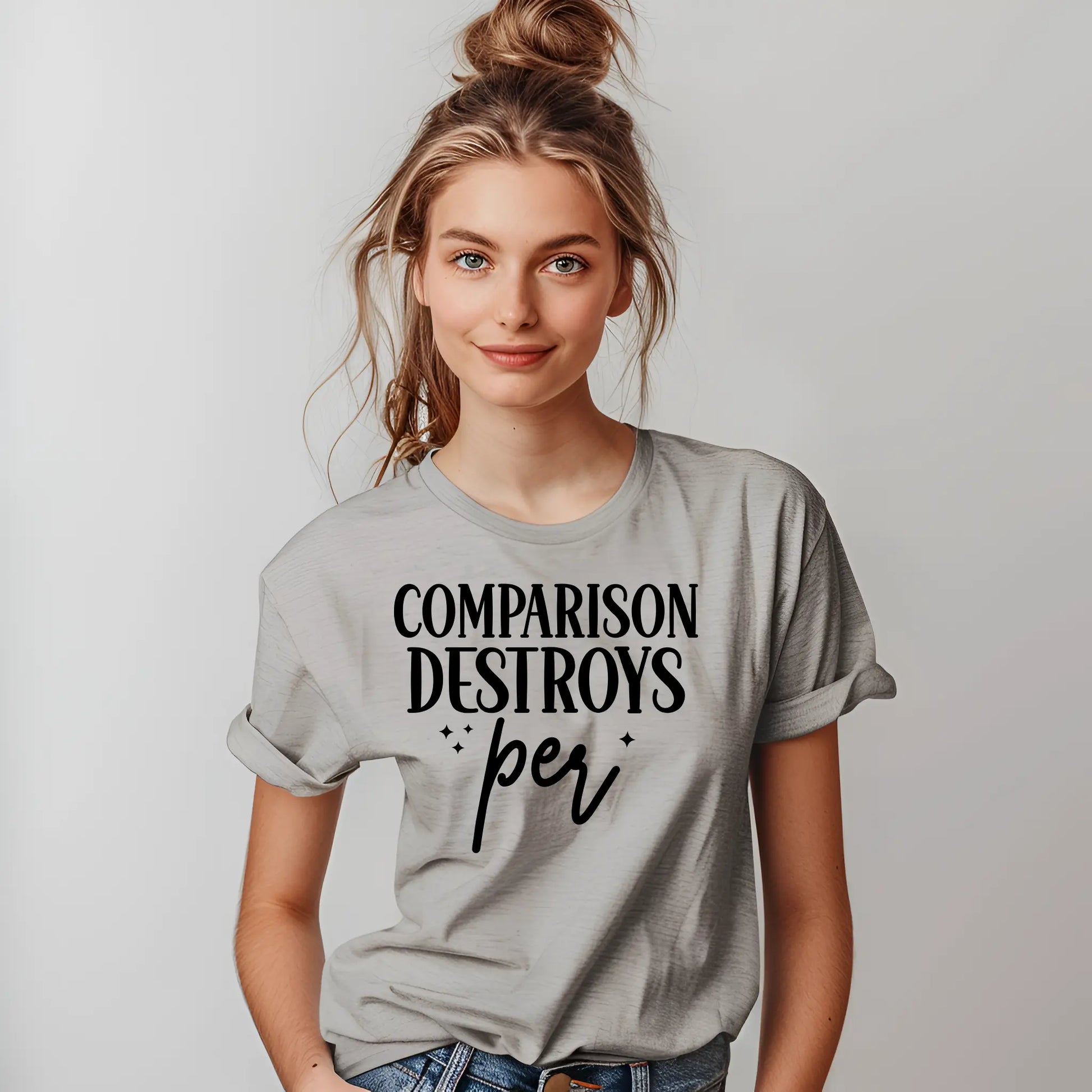 Person wearing a gray t-shirt with 'Comparison Destroys Peri' text on a plain background